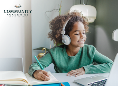 smiling girl with headphones studying on a laptop