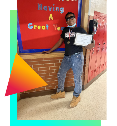 Edith Smith Middle School student holding certificate for math achievement