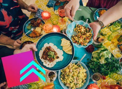 People holding plates filled with tacos and salad