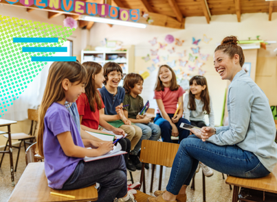 Teacher in Spanish classroom surrounded by students during storytime