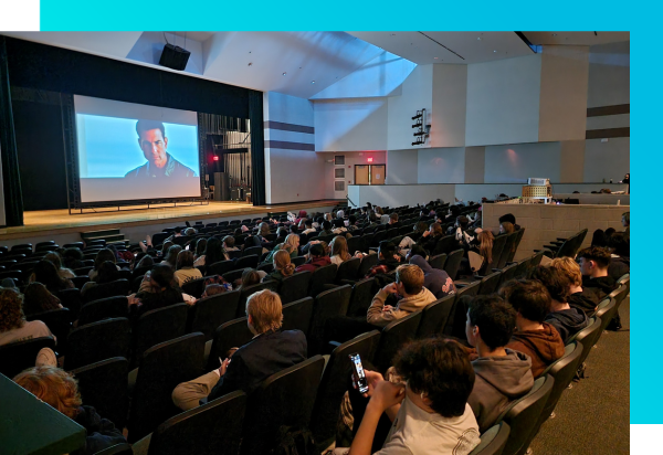 A school auditorium full of students who completed MATHia watching a movie