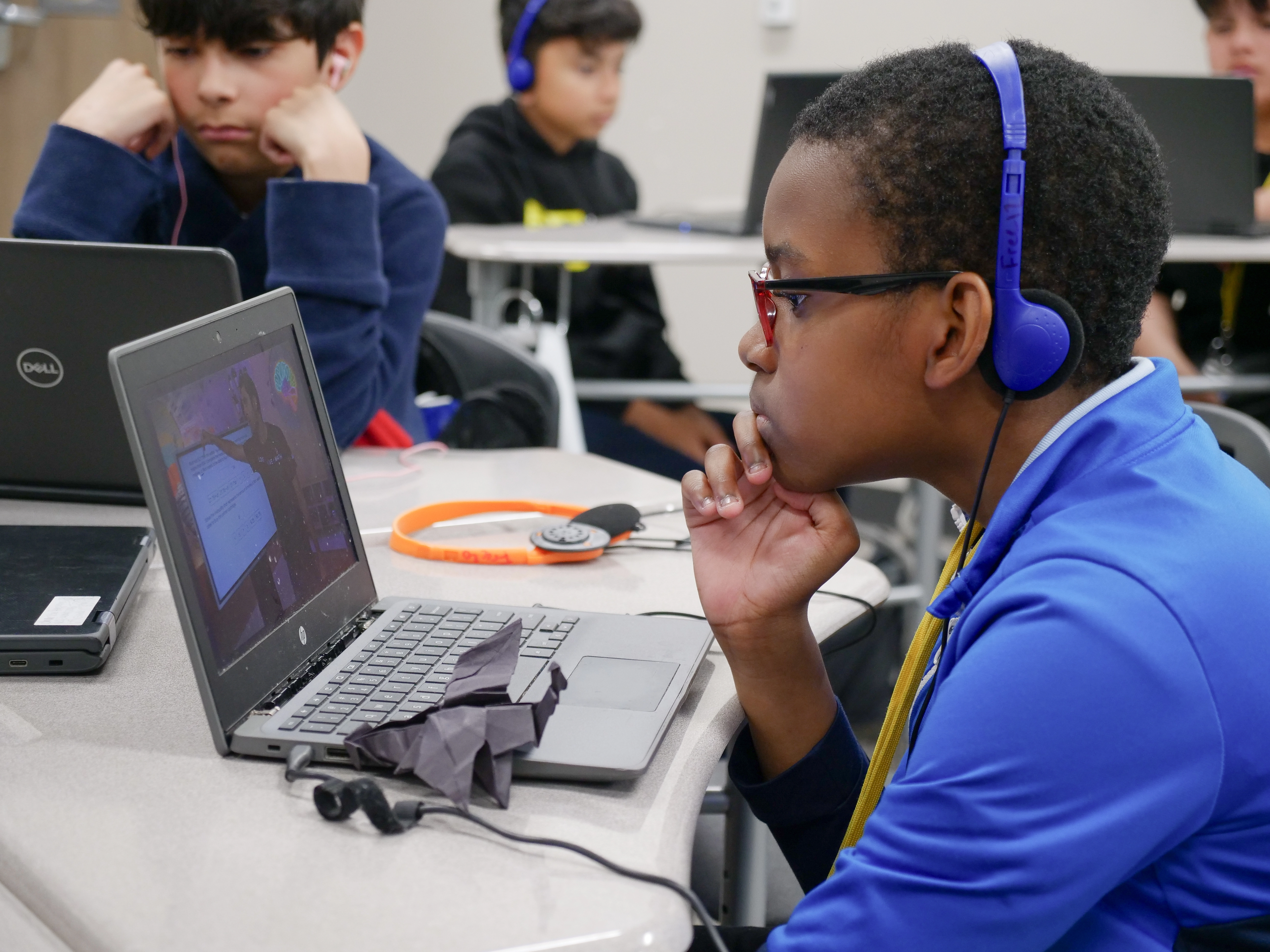 A male student, wearing headphones, working with MATHstream 