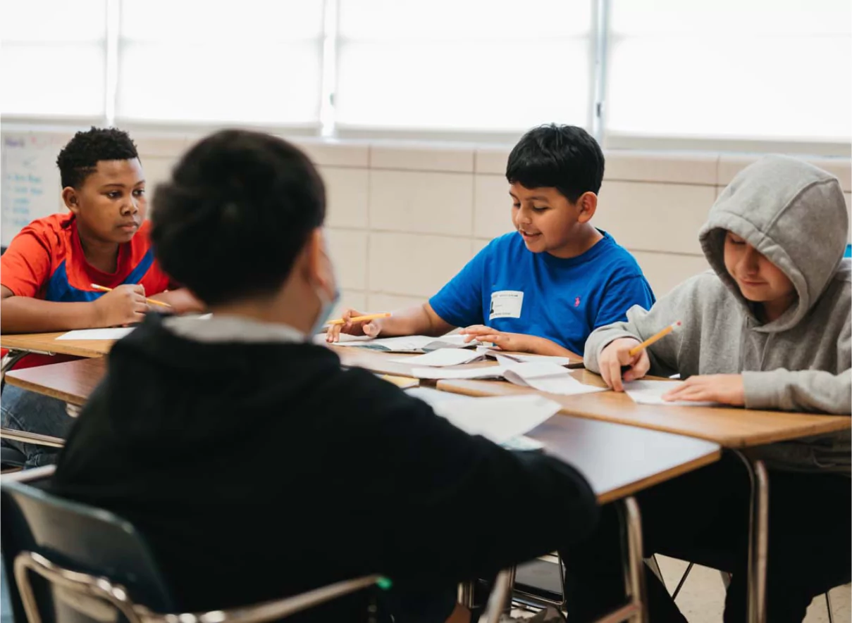 Four middle school students work together in an inclusive classroom.