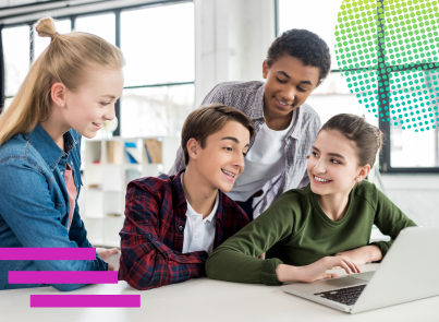 Teenagers gathered around a computer, smiling