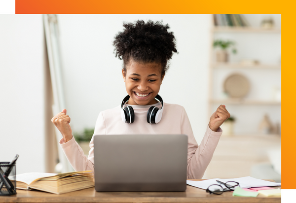 A student is excited to be reading out loud off a laptop screen